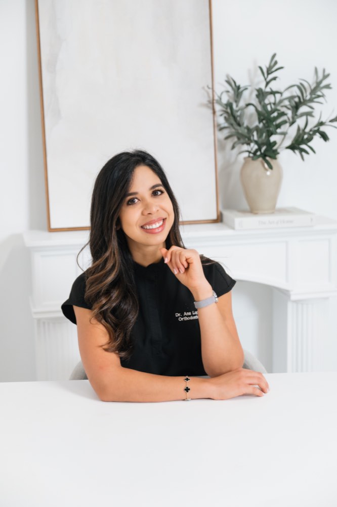 Dr. Ana Lilian Lopez seated at her desk at Dayspring Orthodontics